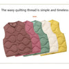 A stack of wavy quilted vests in shades of mauve, pink, mint green, and yellow.