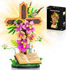 A building set featuring a wooden Jesus cross decorated with colorful flowers and an open Bible.