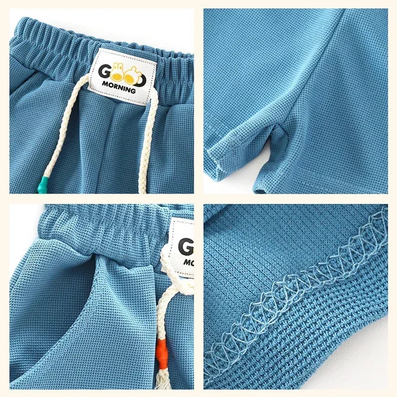 Blue kids beach shorts with elastic waist featuring a grid texture and a white tag.