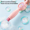 A pink smoke bubble wand is shown shaking to produce bubbles on a light blue background.