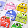 Assortment of colorful and themed sticky notes in various shapes like a pear, frog, and apple