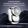 A close-up shot of a silver portable shaver with a textured head resting on a dark surface.