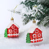 Two red and white candy cane Christmas tree ornaments hanging on a green fir branch