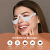 A woman is using a white Red EMS Eye Massager device to relieve eye fatigue and wrinkles.