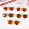 A collection of colorful kids sunglasses featuring various patterns and colors like orange, green, and blue.
