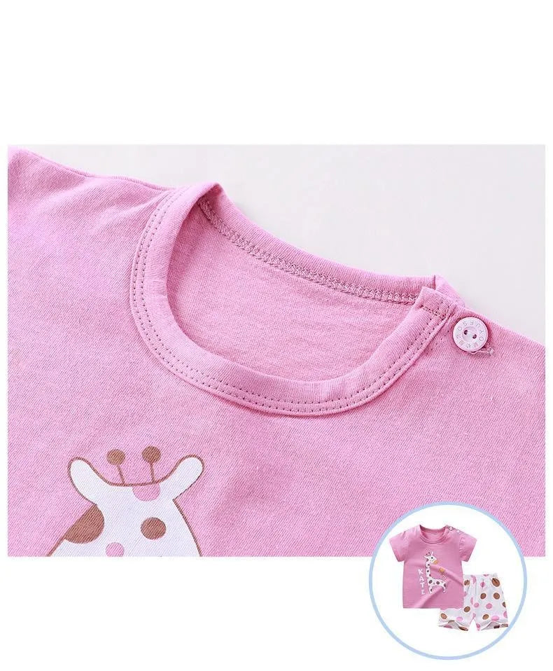 Pink short-sleeve t-shirt and shorts set with a white dinosaur print