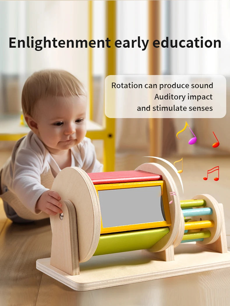 A wooden spinning drum toy for toddlers is shown on a table, demonstrating rotation to stimulate senses.