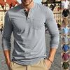 A man models a gray long-sleeve casual shirt with a chest pocket and a V-neck collar.