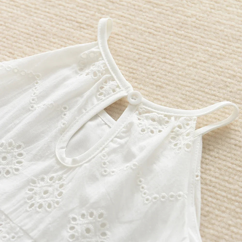 White cotton suspenders dress for a toddler girl with delicate eyelet embroidery