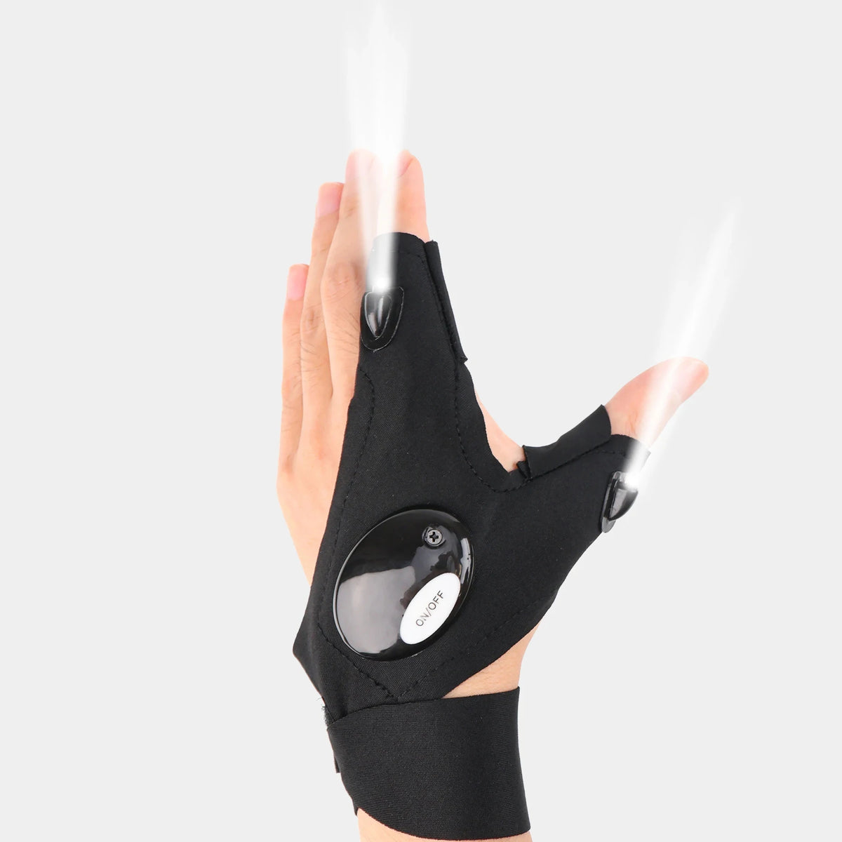 A hand wearing black LED fingerless gloves with a built-in flashlight shining light.