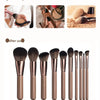 A set of bronze-colored electric makeup brushes and cleaning tools shown before and after use.