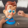 A hand is using a toothpick to poke the mouth of an acne popping squeeze toy character.