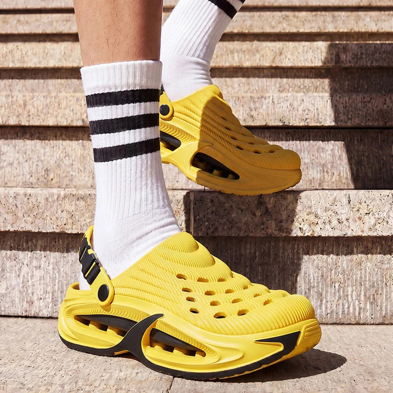 A person wearing yellow EVA slip-on sandals with white socks standing on stone steps.