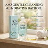 En flaske AMZ Mild Rensende & Fugtgivende Badeolie mærket Skin So Soft ved siden af æske og lille glasfad.