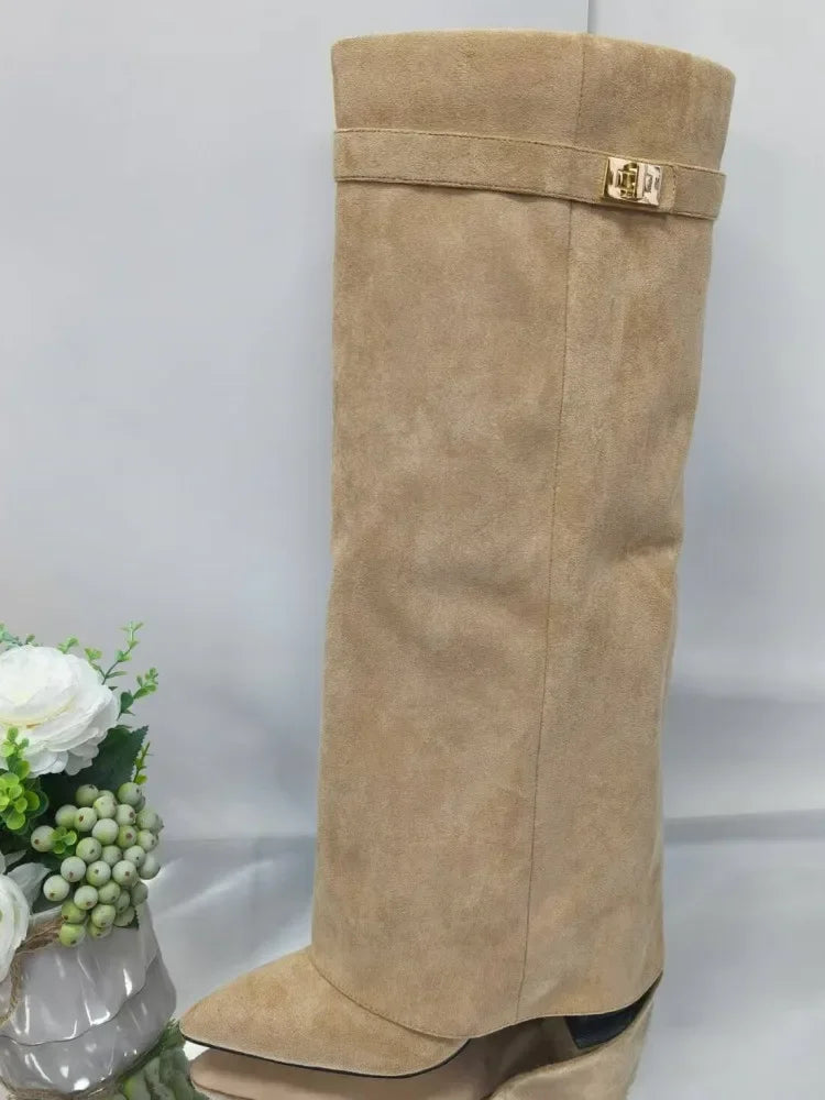 A full-length view of a beige knee-high boot with a chunky heel and a metal buckle detail.
