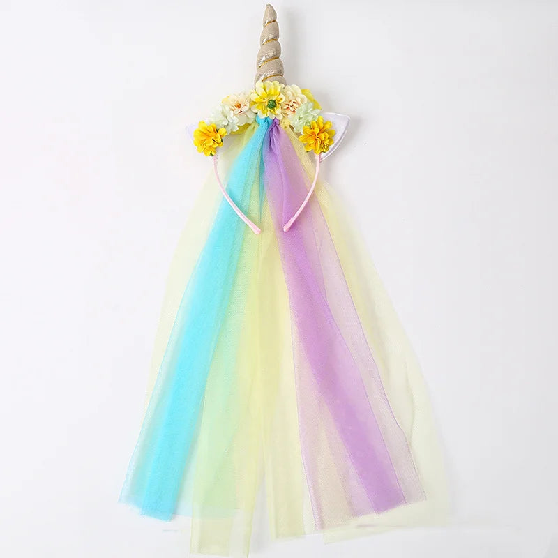 A colorful unicorn mesh headband featuring yellow flowers and iridescent pastel ribbons.