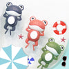Three wind-up frog bath toys in gray, pink, and green are shown against a white background.