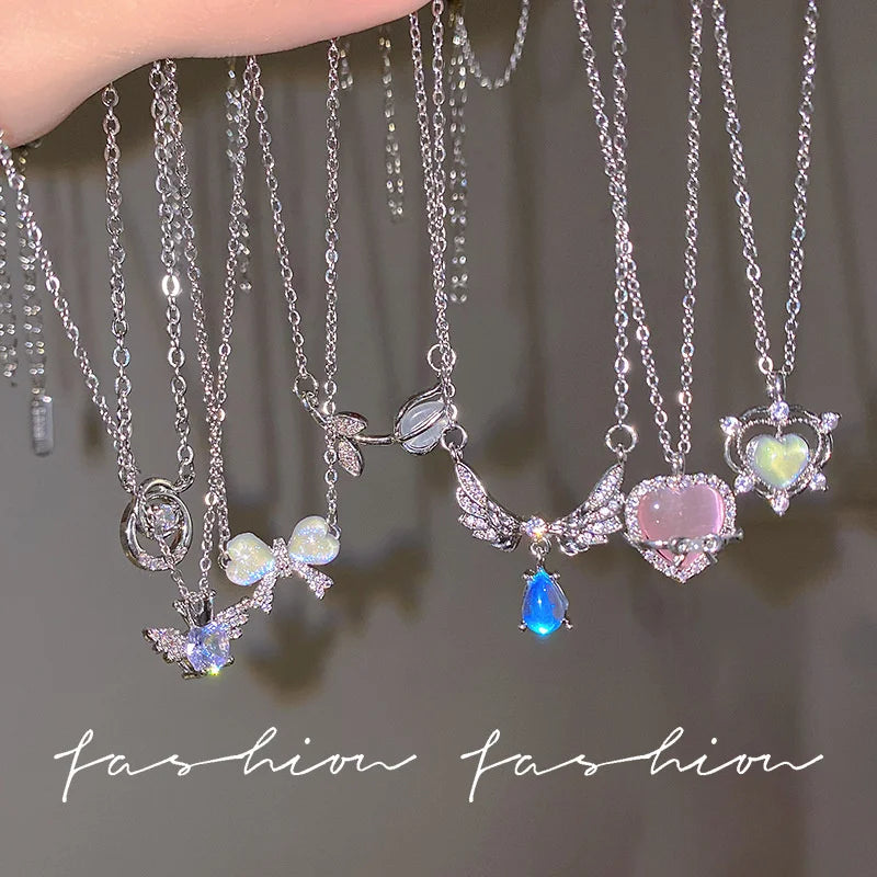 Silver crystal bow angel wings heart pendant necklace with pink and blue accents