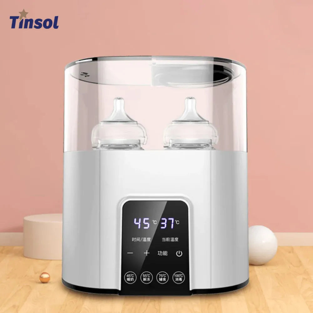 A white multi-function baby bottle warmer and sterilizer appliance sitting on a wooden surface.