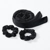 Black heatless curling rod headband rolled into a fabric band and separate looped pieces