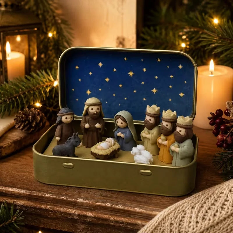 A miniature nativity scene featuring figures and animals displayed inside a gold-colored metal box with a blue starry lid.