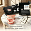 A complete veneer kit with storage box, toothbrush, and removal hook displayed on a marble surface.