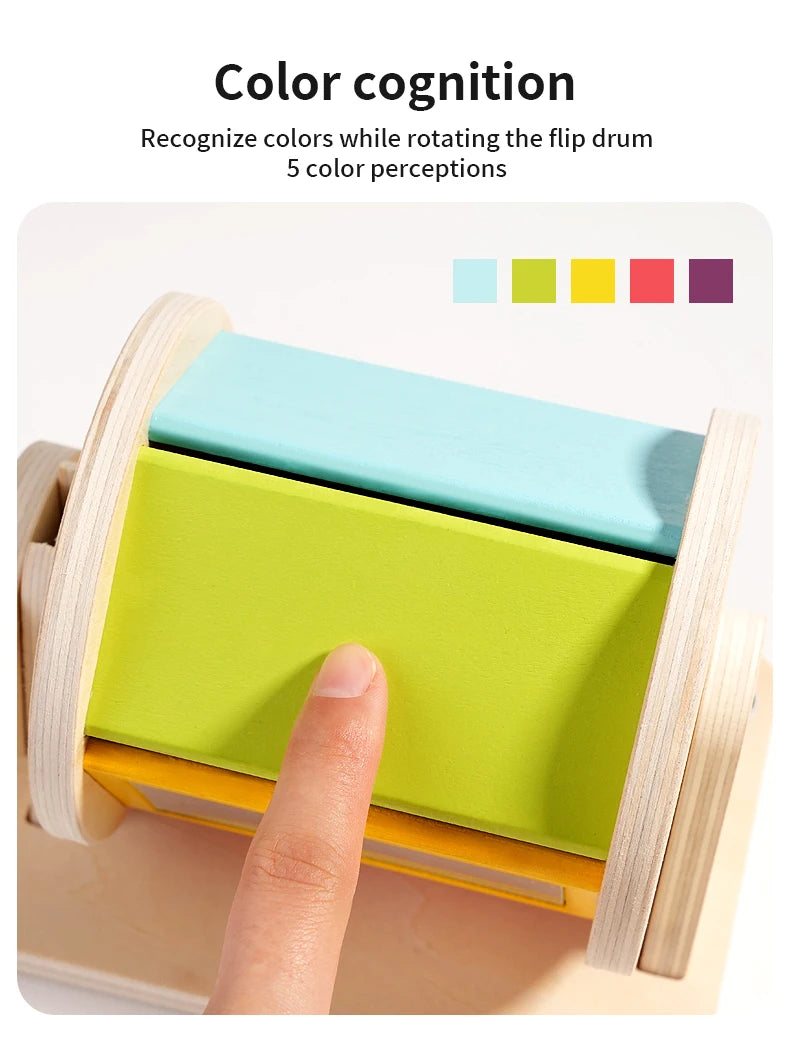 A hand rotates a wooden spinning drum showing five different colors for color cognition training.