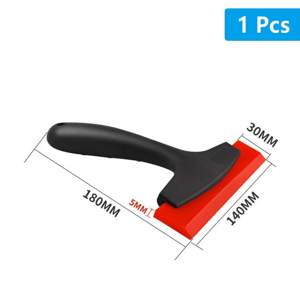 A black tile gap filling and cleaning scraper tool with a red base, shown at an angle.