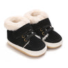 Pair of black baby winter snow boots with fluffy cream faux fur trim and white soles.