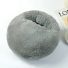 A round, gray fleece cover for a USB heated foot warmer product.