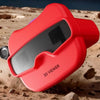 A red 3D viewer device is shown resting on rocky, desert-like terrain.
