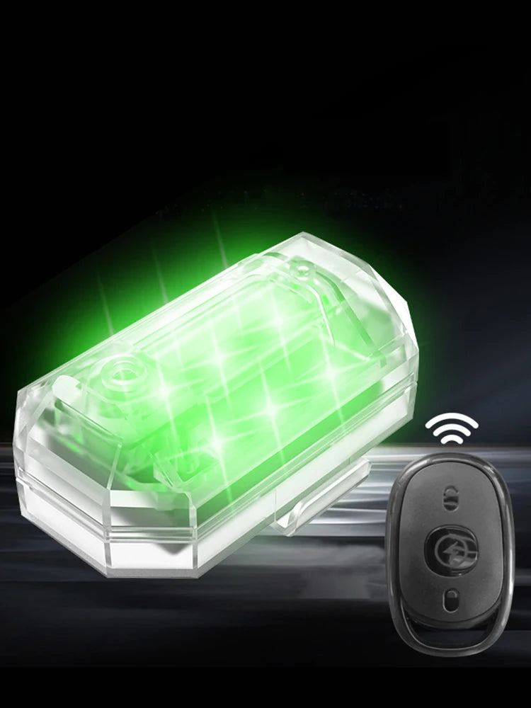 A clear plastic strobe light unit with a green LED glow and a wireless receiver module.
