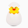 A yellow duck toy is visible inside a white egg-shaped bath toy container.