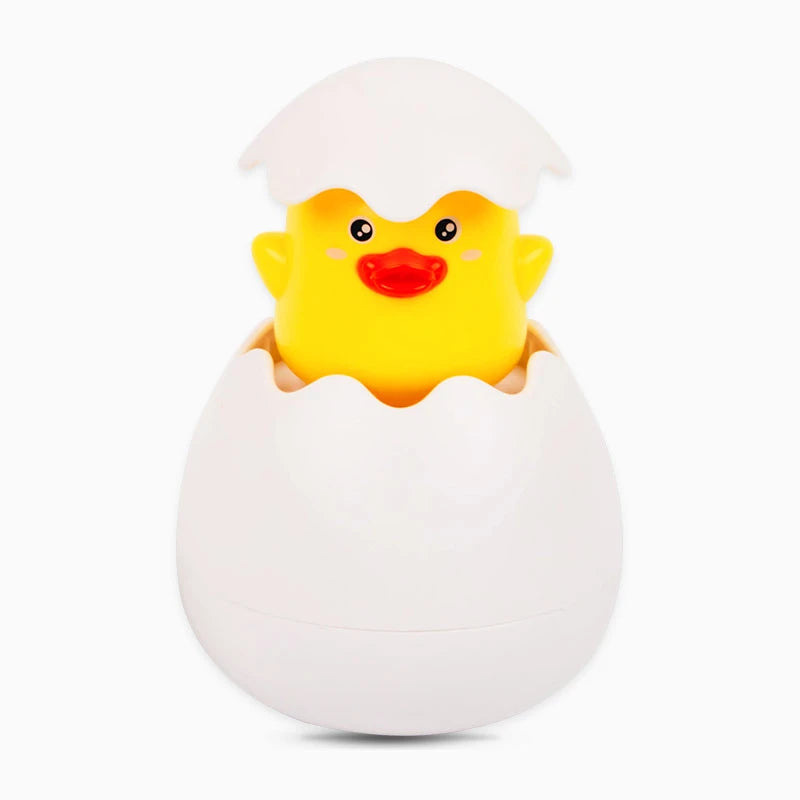 A yellow duck toy is visible inside a white egg-shaped bath toy container.