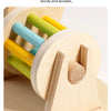 A close-up of a wooden spinning drum with colorful dowels, made from solid oak wood.