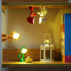 A cartoon hero police night light for kids is displayed in a wooden shelf with various illuminated toys.