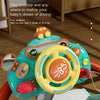 A bright blue interactive steering wheel toy with a yellow steering wheel and orange accents is shown on a wooden surface.