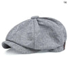 A grey vintage retro newsboy cap with a folded brim shown from above.
