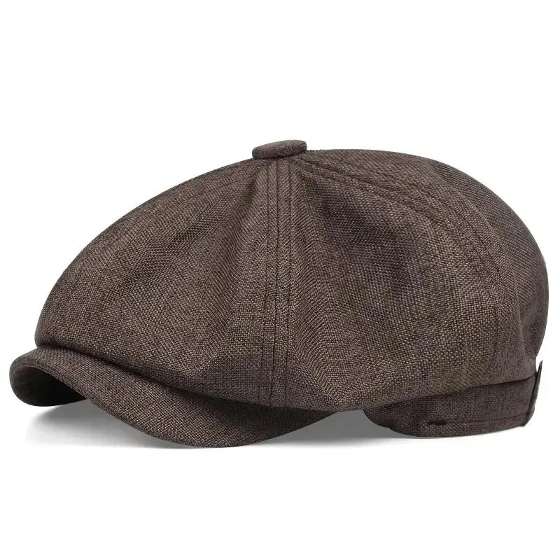 A dark brown vintage newsboy cap with a folded brim shown from the top.