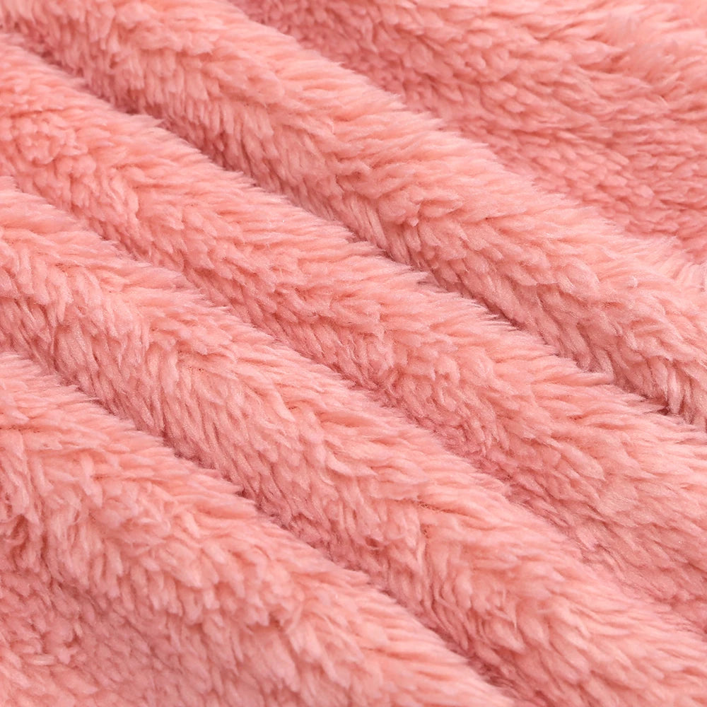 Close-up of a pink baby fleece hooded romper with a zipper texture.