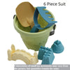 A six-piece sand play set featuring a green bucket, a shovel, and various sand molds and accessories.