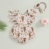 A floral cow print baby romper with matching headband shown flat lay.