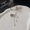 A delicate silver butterfly flower ear cuff with sparkling zircon accents displayed on a white background.