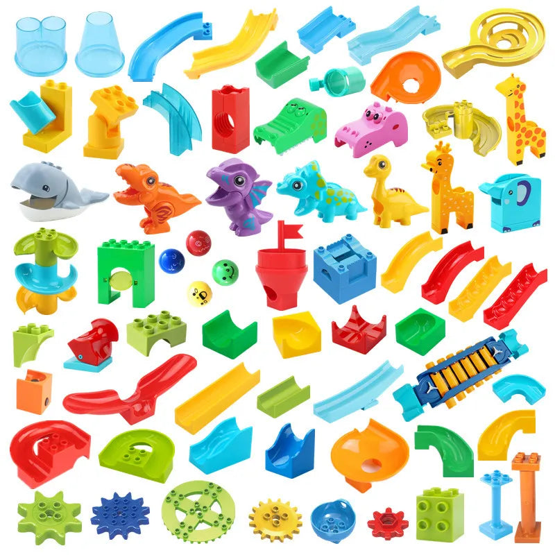 A collection of colorful marble run building blocks, including tracks, funnels, and various geometric shapes.