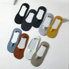 A collection of five men's no-show socks with silicone grips in various colors including black, gray, olive green, and brown.