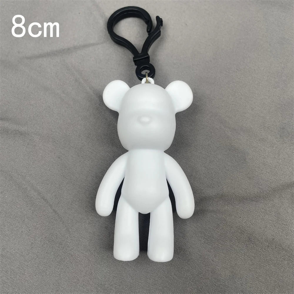 A white bear figurine with a black hanging loop, shown against a gray background.
