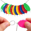 A set of colorful needle threaders with various colored plastic tips shown against a white background.