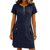 A woman wearing a navy blue lightweight cotton-linen short sleeve dress with a collar and front zipper and side pockets.