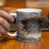 Keramisk kaffekopp med design av stablede bøker og sider som en ødelagt bokhylle