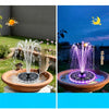A solar floating water fountain with RGB LED lights operating in a garden setting at night.
